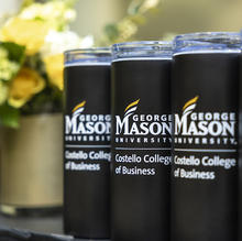 A row of travel mugs bearing the George Mason University Costello College of Business logo